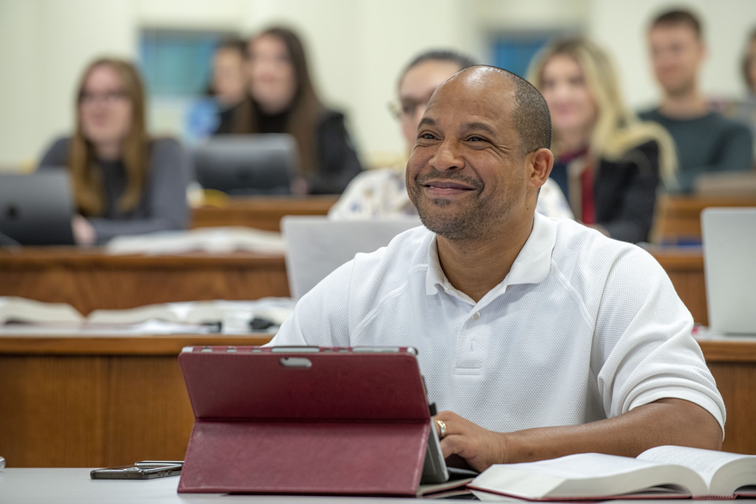 Man smiles in classroom